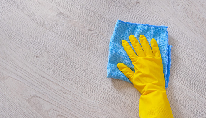 New homeowner cleaning new vinyl floors