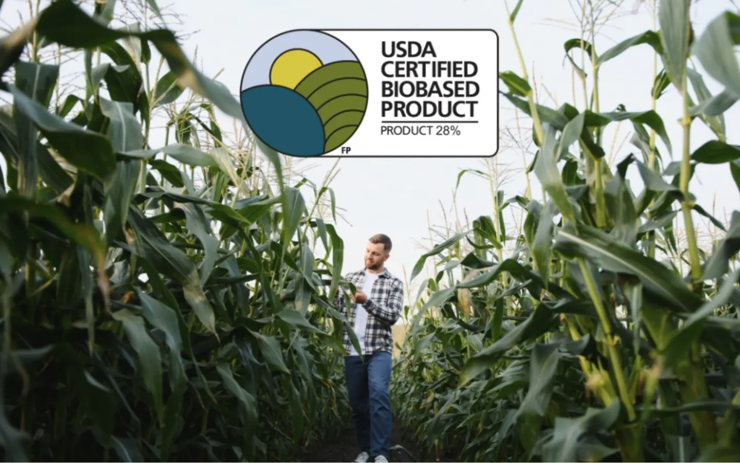 Farmer walking through a cornfield with USDA Certified Biobased badge.